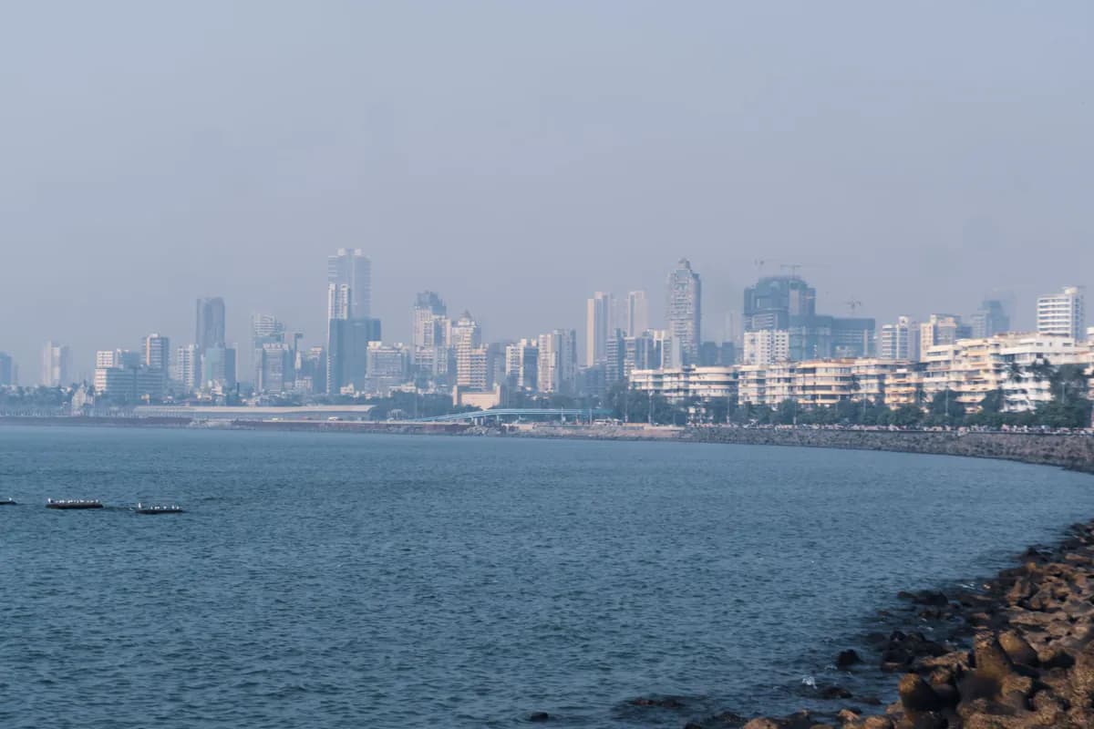 The curving sea wall of Marine Drive and the Arabian Sea in Mumbai, with apartment blocks and towers along the shore