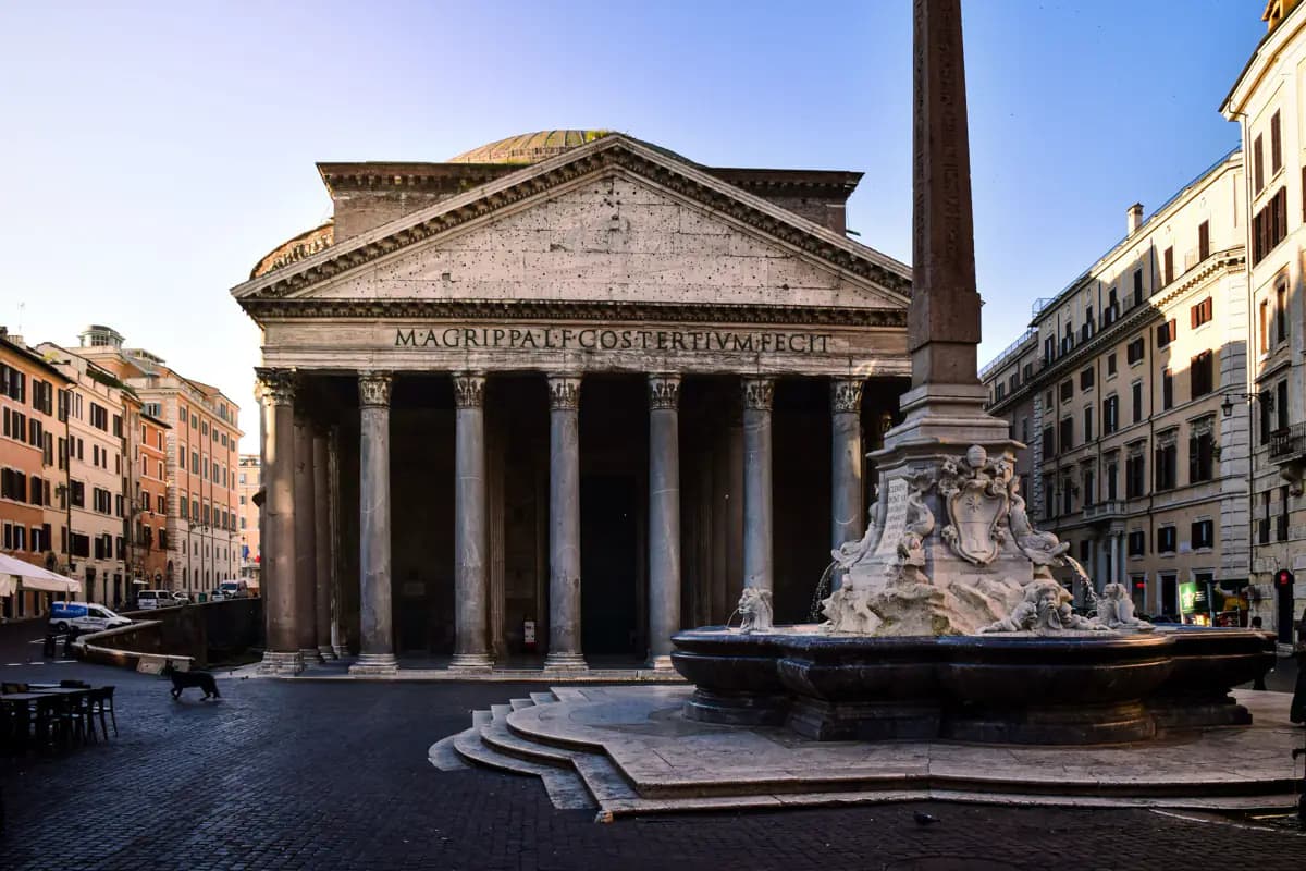 The columned portico and dome of the Pantheon in Rome, with a fountain and obelisk in the quiet square in front